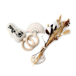 2 maple wood teething rings with organic cotton prints sewing onto maple wood rings.