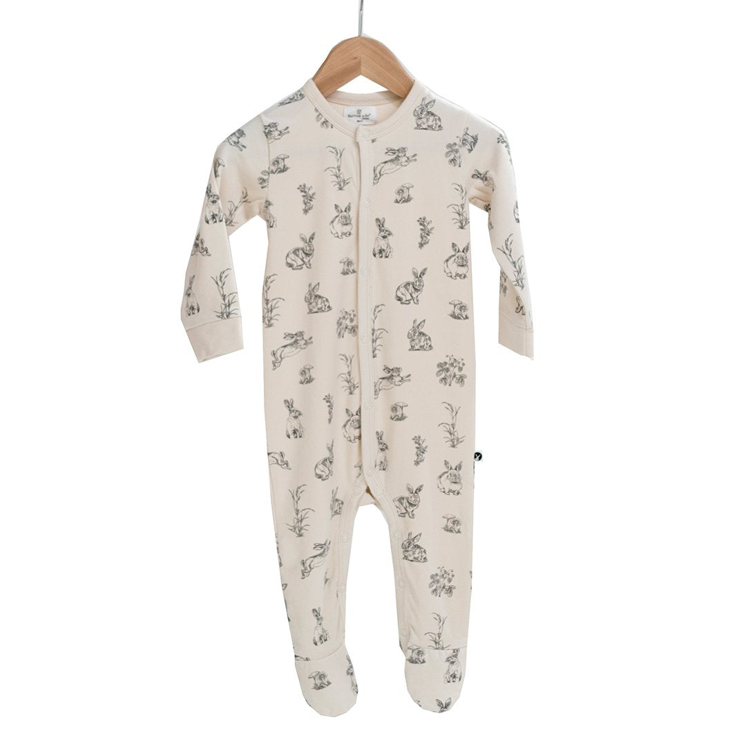 Baby sleep suit in natural almond with rabbit design.