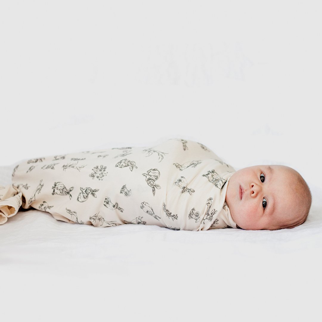 stretchy swaddle in natural almond with rabbit burrower design.