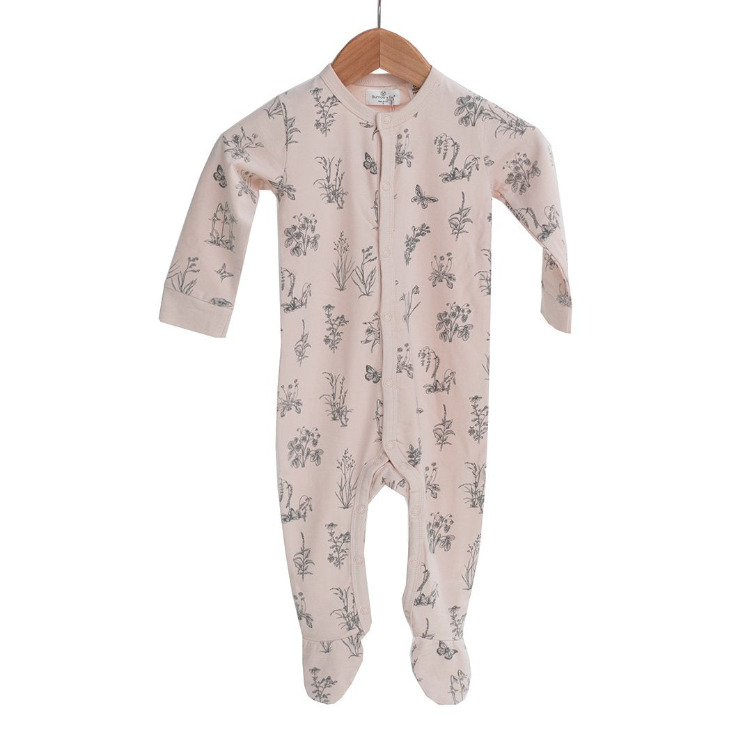 Newborn sleep suit in blush pink with meadow design