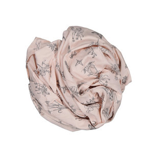baby fitted cot sheets rolled up into ball; pink with grey meadow print.