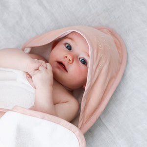 Baby with pink organic hooded towel