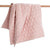 Baby girl cot quilt baby floor mat in dusty rose with geometric quilted pattern.