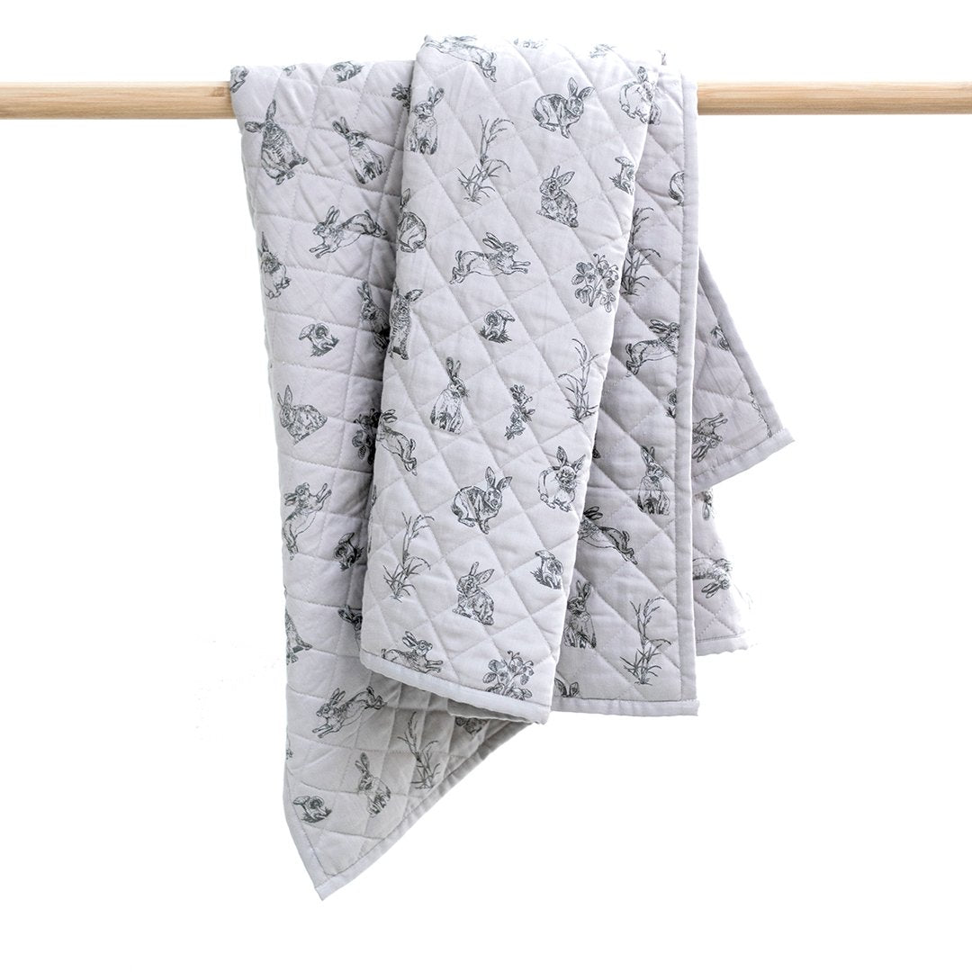 Cot quilt; baby boy cot quilt in grey with rabbit print and diamond quilt pattern.