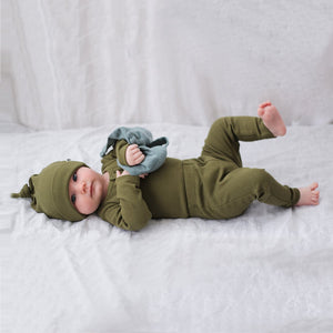 Olive rib leggings baby boy. Baby laying down and wearing olive outfit and knot top beanie.
