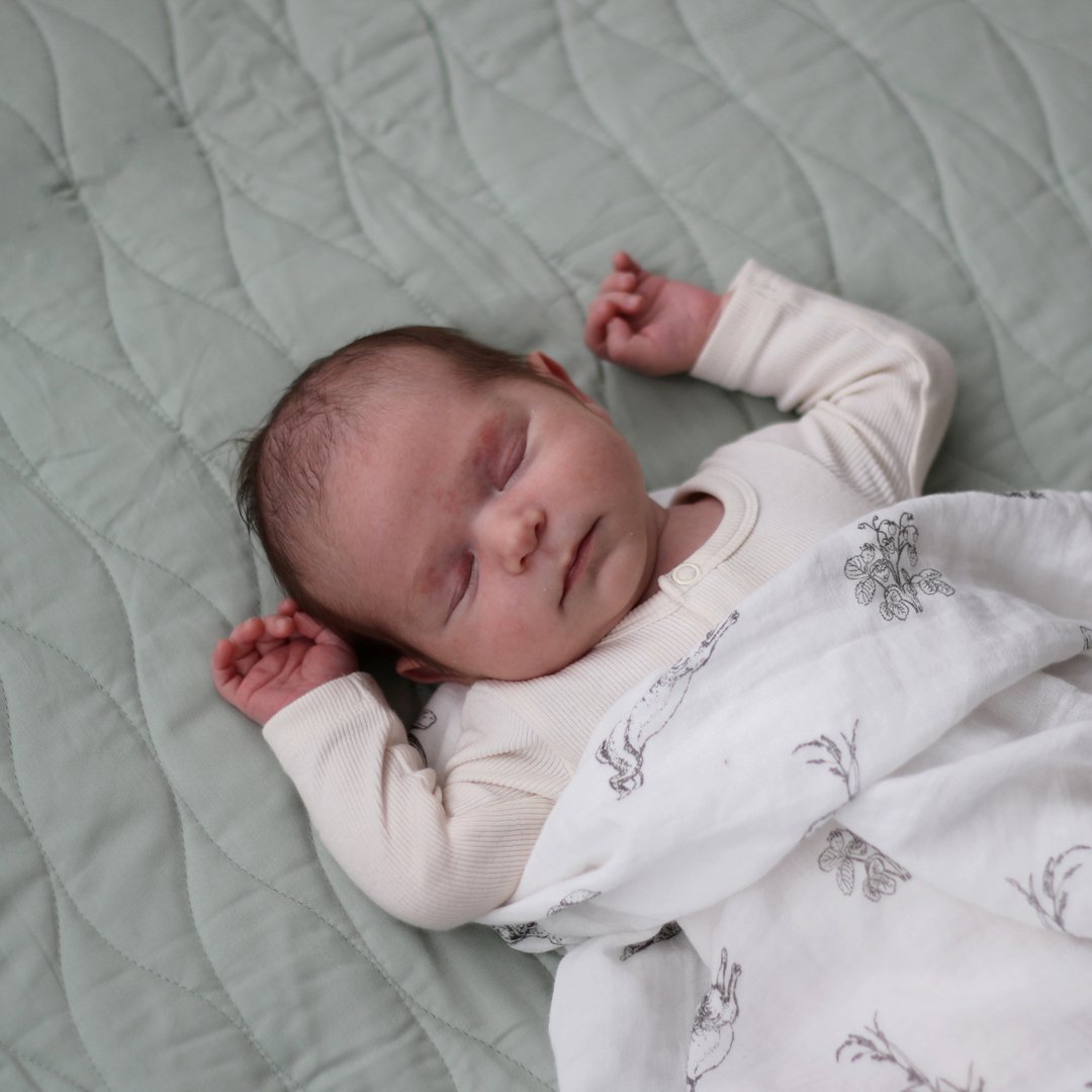 Quilt for baby cot, soft baby floor mat in sage with geometric quilt pattern.
