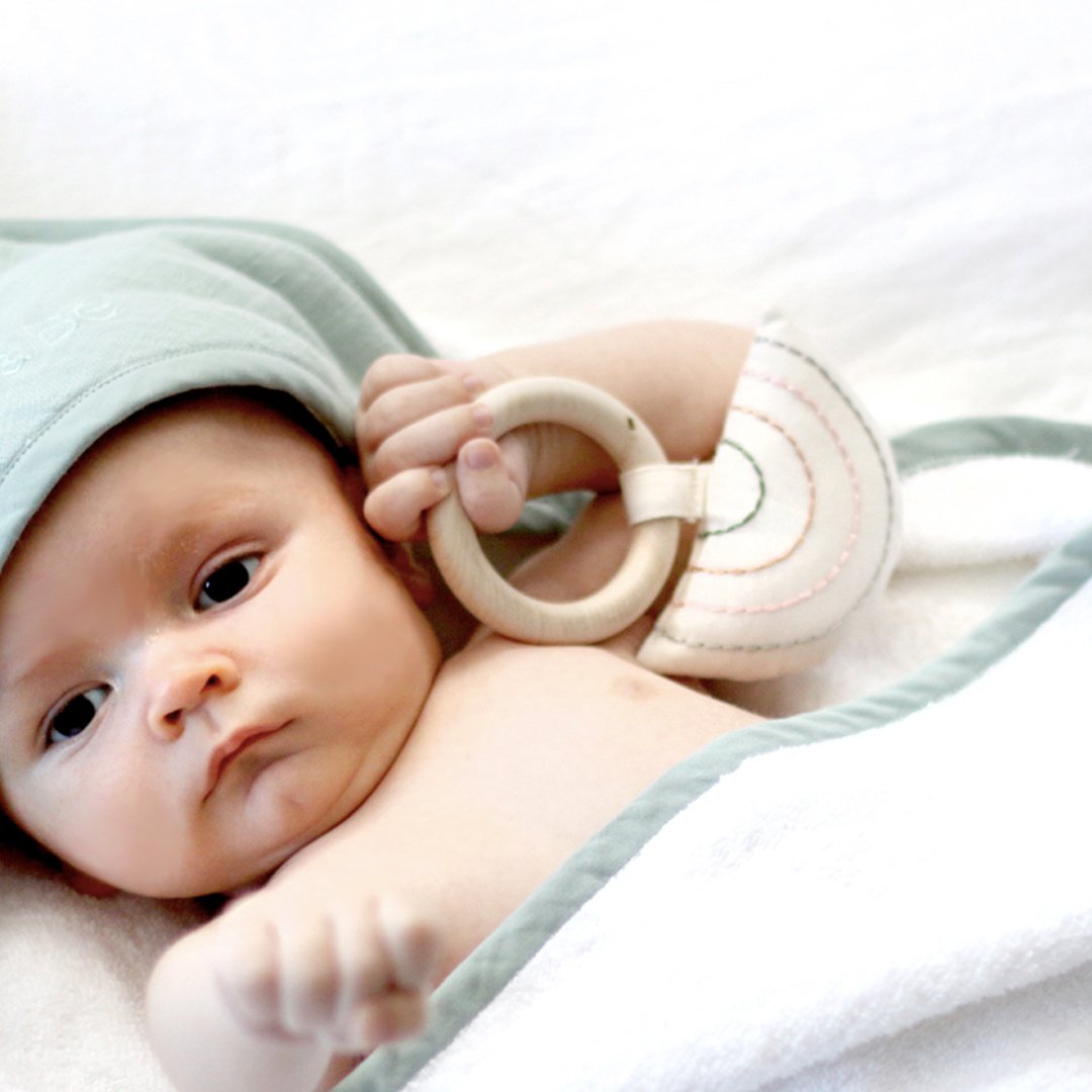 2 maple wood teething rings with organic cotton prints sewing onto maple wood rings. 