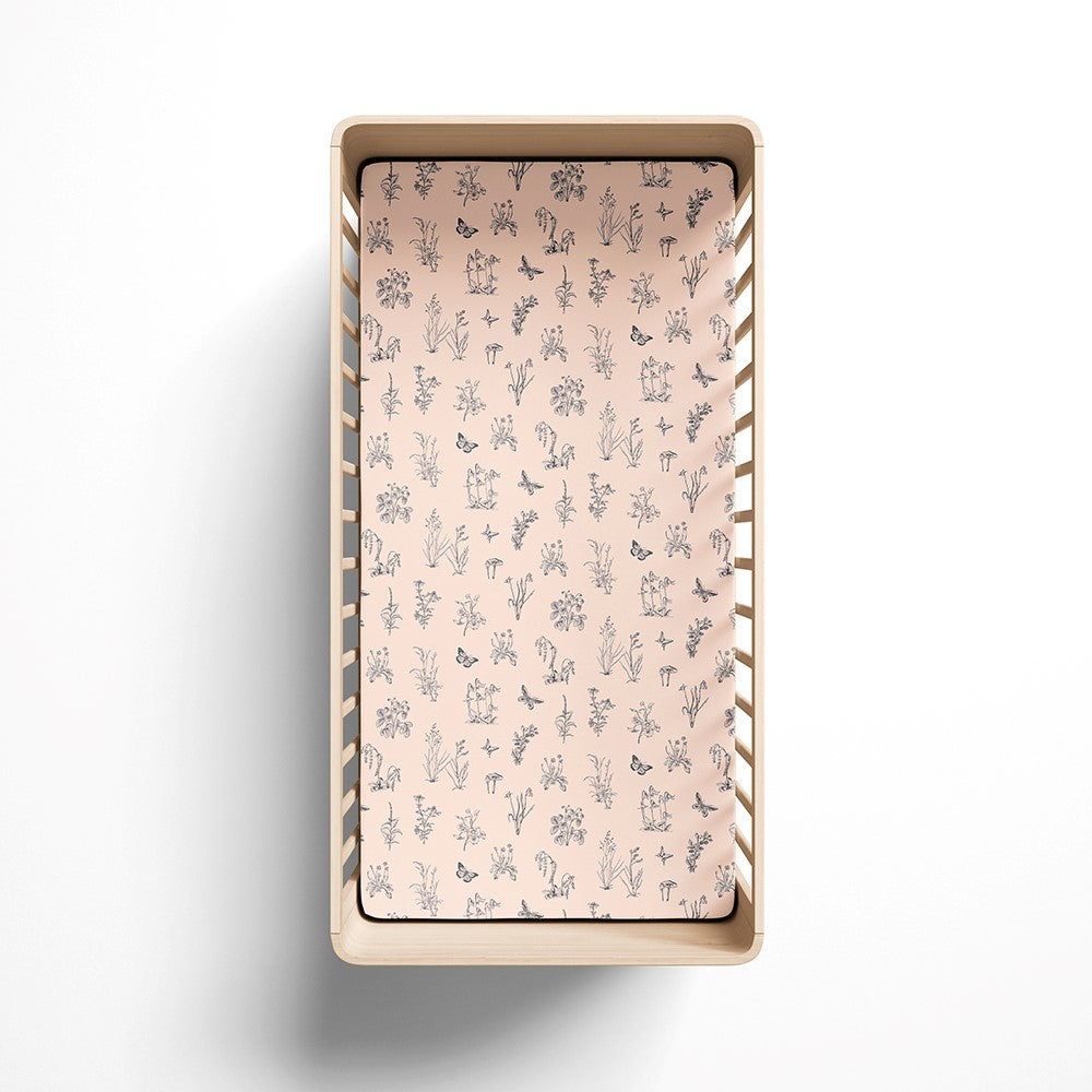 organic fitted cot sheet in light pink with grey meadow print