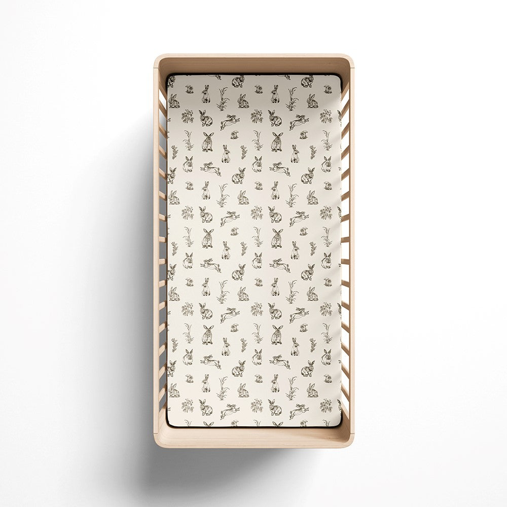 Baby cot fitted sheet in almond colour with rabbit print in a gift box.