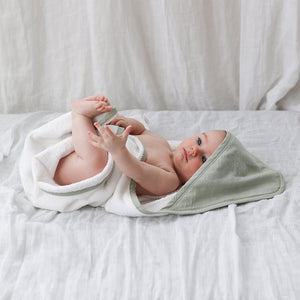 Baby with organic hooded towel in sage